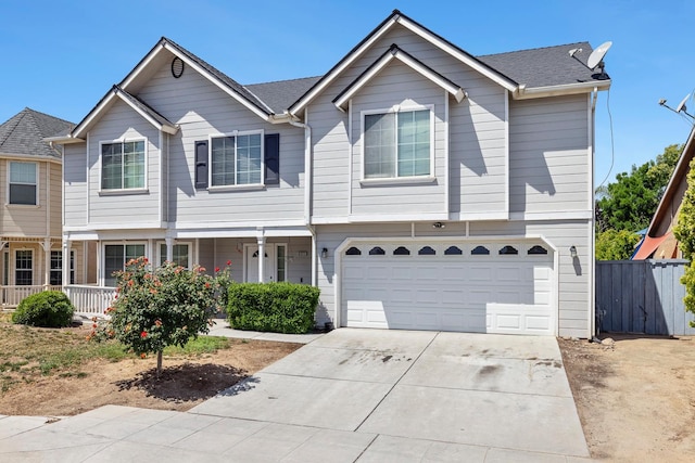 6371 N Babigian Ave, Fresno, CA 93722 - view of property with a garage, driveway, fence, and a porch