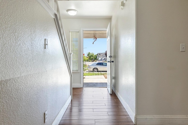 6371 N Babigian Ave, Fresno, CA 93722 - corridor featuring baseboards, a textured wall, and dark wood finished floors