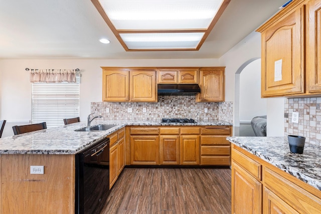 6371 N Babigian Ave, Fresno, CA 93722 - kitchen featuring dishwasher, a sink, under cabinet range hood, light stone countertops, and dark wood-type flooring