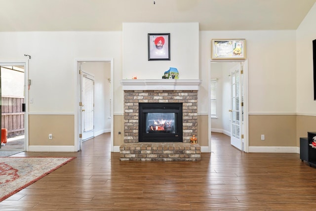 6371 N Babigian Ave, Fresno, CA 93722 - living area featuring a brick fireplace, wood finished floors, and baseboards
