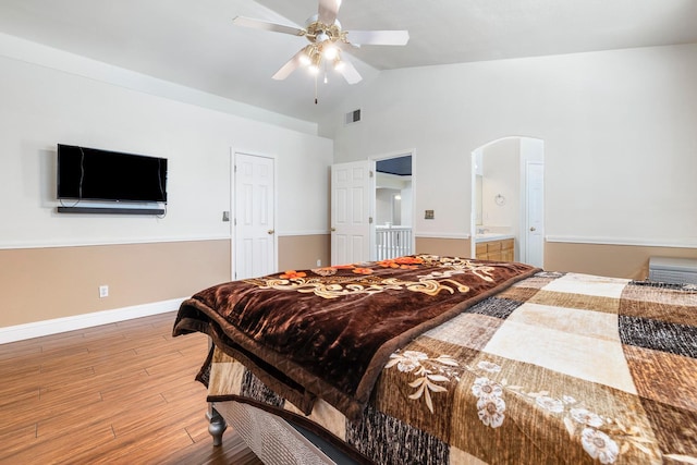 6371 N Babigian Ave, Fresno, CA 93722 - bedroom featuring arched walkways, light wood finished floors, high vaulted ceiling, baseboards, and ceiling fan
