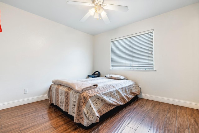6371 N Babigian Ave, Fresno, CA 93722 - bedroom with baseboards, wood finished floors, and ceiling fan