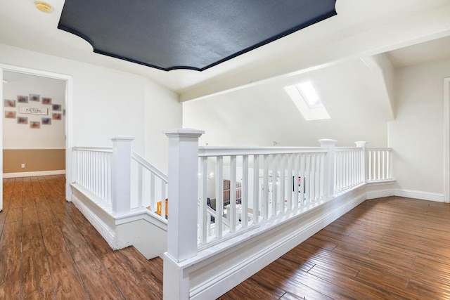 6371 N Babigian Ave, Fresno, CA 93722 - hall featuring a skylight, hardwood / wood-style flooring, baseboards, and an upstairs landing