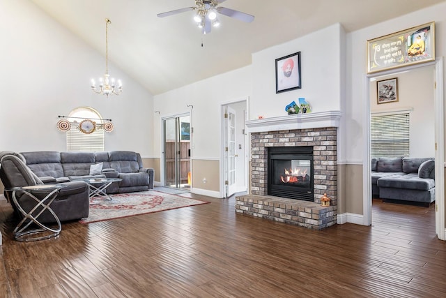 6371 N Babigian Ave, Fresno, CA 93722 - living area featuring high vaulted ceiling, a ceiling fan, a fireplace, a chandelier, and dark wood-style flooring