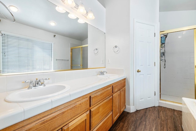 6371 N Babigian Ave, Fresno, CA 93722 - full bathroom with a shower stall, wood finished floors, and double vanity