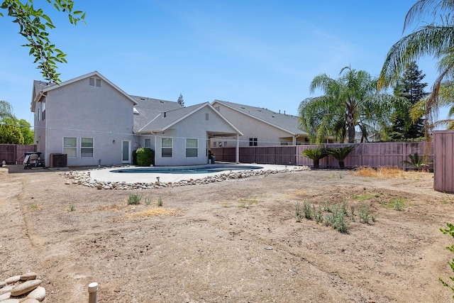 6371 N Babigian Ave, Fresno, CA 93722 - back of property with a fenced backyard, stucco siding, and central AC