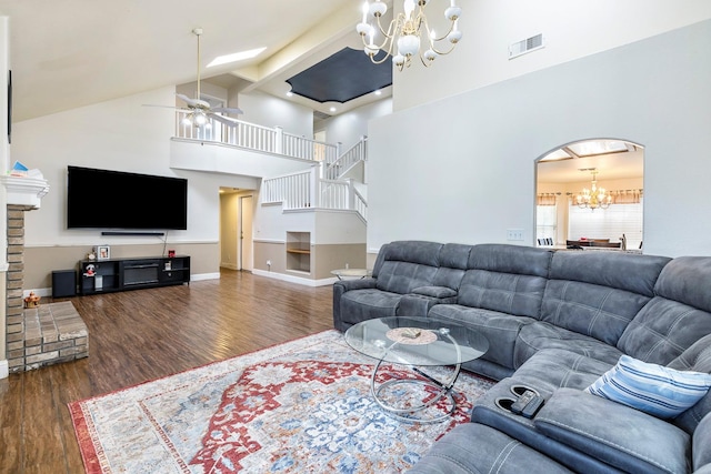 6371 N Babigian Ave, Fresno, CA 93722 - living room featuring a chandelier, wood finished floors, high vaulted ceiling, stairway, and ceiling fan