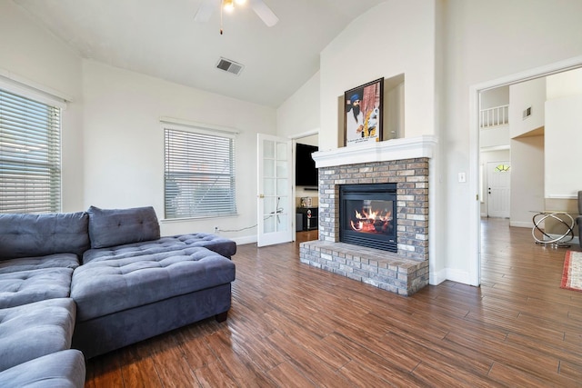 6371 N Babigian Ave, Fresno, CA 93722 - living room featuring high vaulted ceiling, ceiling fan, a fireplace, dark wood-style flooring, and baseboards