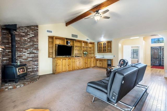 37086 Marciel Ave, Madera, CA 93636 - living room featuring arched walkways, a ceiling fan, a wood stove, and wood-type flooring