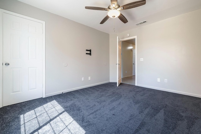 37086 Marciel Ave, Madera, CA 93636 - unfurnished bedroom with dark colored carpet, baseboards, and a ceiling fan