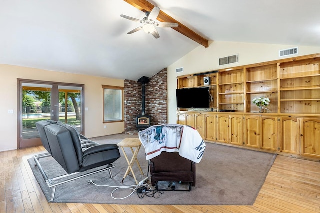 37086 Marciel Ave, Madera, CA 93636 - living area with a wood stove, french doors, ceiling fan, and light wood-style flooring