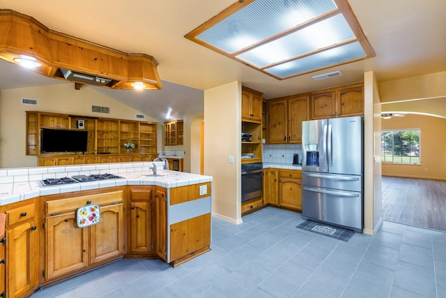 37086 Marciel Ave, Madera, CA 93636 - kitchen with appliances with stainless steel finishes, backsplash, open floor plan, a sink, and brown cabinetry