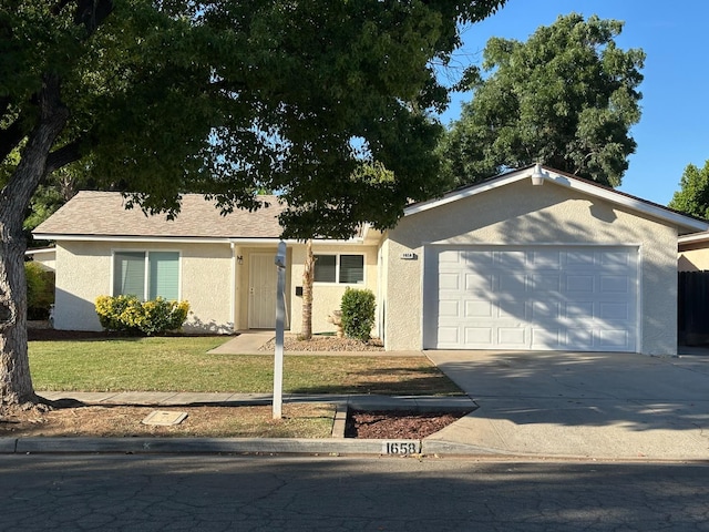 1658 E Paul Ave, Fresno, CA 93710 - single story home with stucco siding, an attached garage, concrete driveway, and a front lawn
