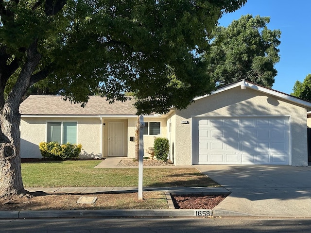 1658 E Paul Ave, Fresno, CA 93710 - ranch-style house featuring stucco siding, a garage, concrete driveway, and a front yard