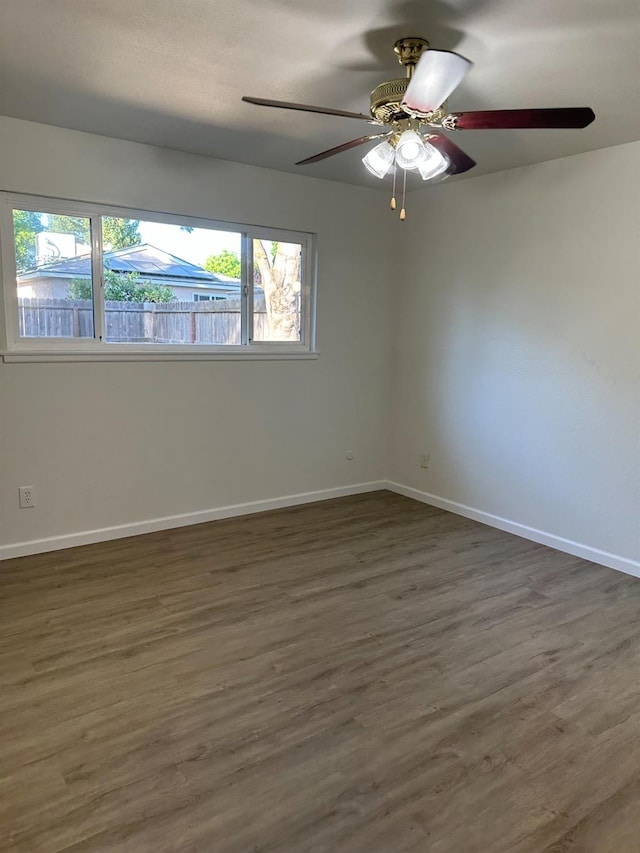 1658 E Paul Ave, Fresno, CA 93710 - empty room with ceiling fan, wood finished floors, and baseboards