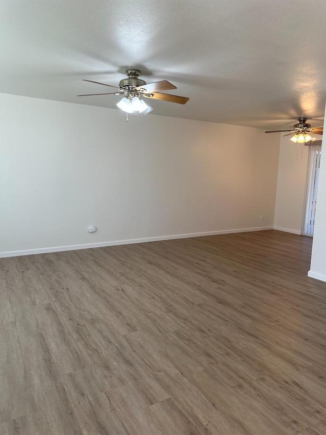1658 E Paul Ave, Fresno, CA 93710 - empty room with a ceiling fan, wood finished floors, and baseboards
