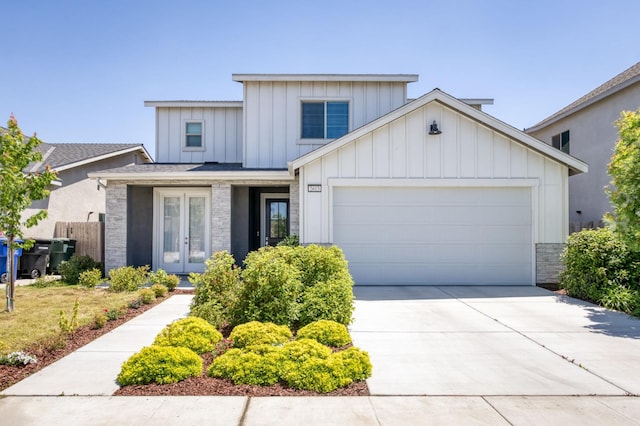 2613 W Mallard, Hanford, CA 93230 - view of front of house with board and batten siding, an attached garage, concrete driveway, french doors, and fence