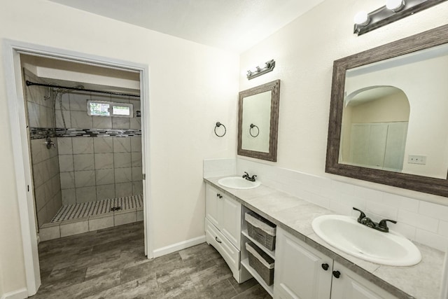 1079 E El Paso Ave, Fresno, CA 93720 - bathroom with double vanity, a shower stall, backsplash, and wood finished floors