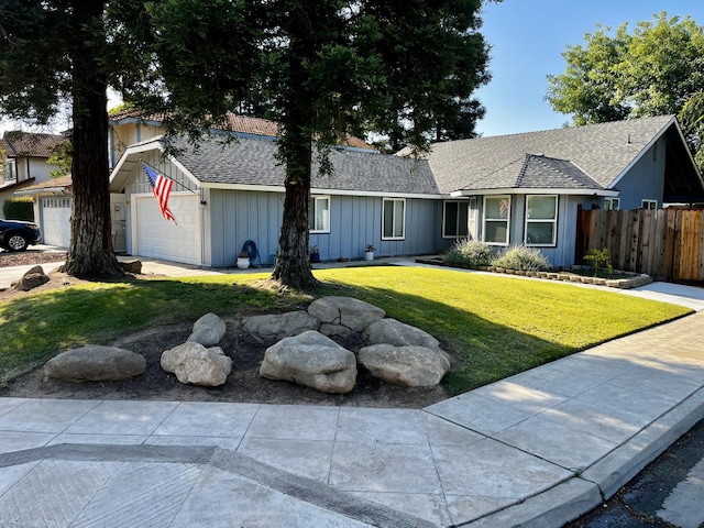 1079 E El Paso Ave, Fresno, CA 93720 - single story home with board and batten siding, roof with shingles, and a garage