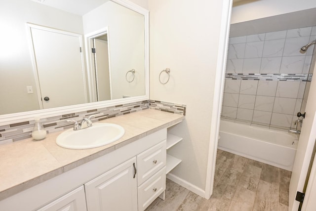 1079 E El Paso Ave, Fresno, CA 93720 - full bath with vanity, bathtub / shower combination, decorative backsplash, and wood finished floors