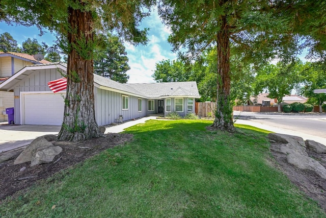 1079 E El Paso Ave, Fresno, CA 93720 - view of front of home with board and batten siding, a garage, and concrete driveway