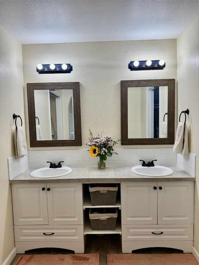 1079 E El Paso Ave, Fresno, CA 93720 - bathroom featuring tasteful backsplash, double vanity, and baseboards