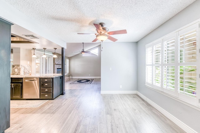 6211 N Cleo Ave, Fresno, CA 93722 - kitchen featuring stainless steel dishwasher, a ceiling fan, a textured ceiling, light wood-style flooring, and baseboards