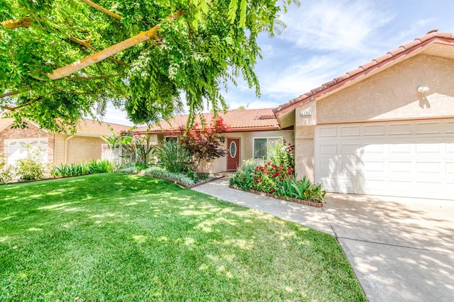 6211 N Cleo Ave, Fresno, CA 93722 - ranch-style house featuring a tiled roof, stucco siding, a front yard, driveway, and a garage
