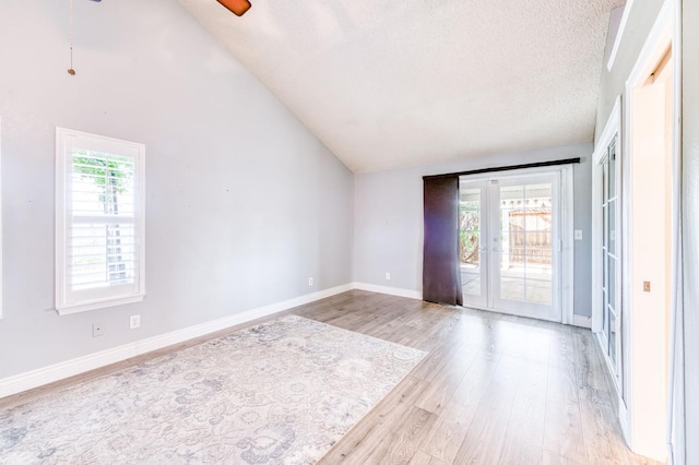 6211 N Cleo Ave, Fresno, CA 93722 - unfurnished room featuring lofted ceiling, light wood-style flooring, ceiling fan, baseboards, and a textured ceiling