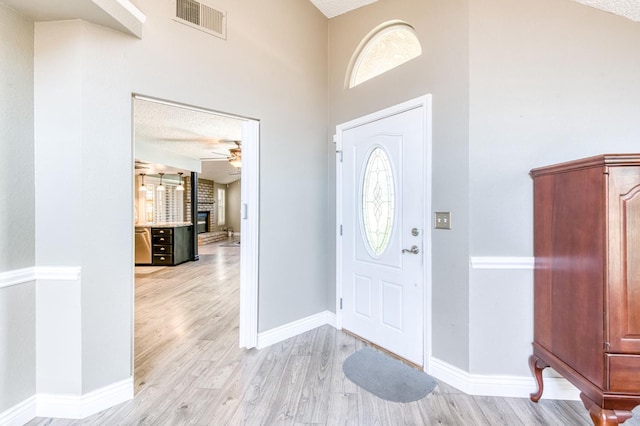 6211 N Cleo Ave, Fresno, CA 93722 - foyer entrance with a ceiling fan, light wood-type flooring, healthy amount of natural light, and a textured ceiling
