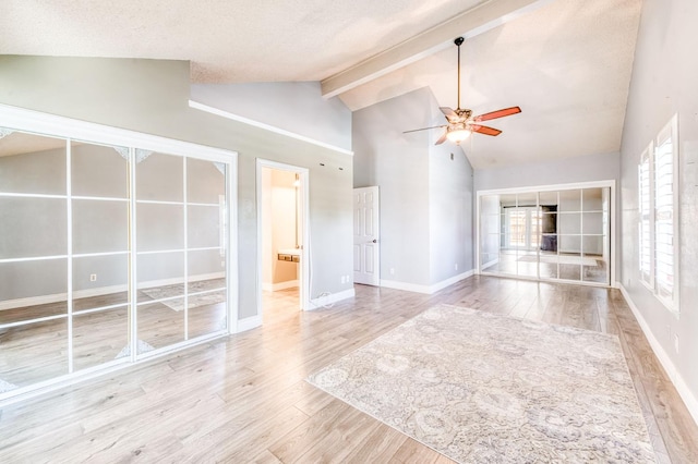 6211 N Cleo Ave, Fresno, CA 93722 - unfurnished living room featuring a ceiling fan, wood finished floors, beamed ceiling, baseboards, and high vaulted ceiling
