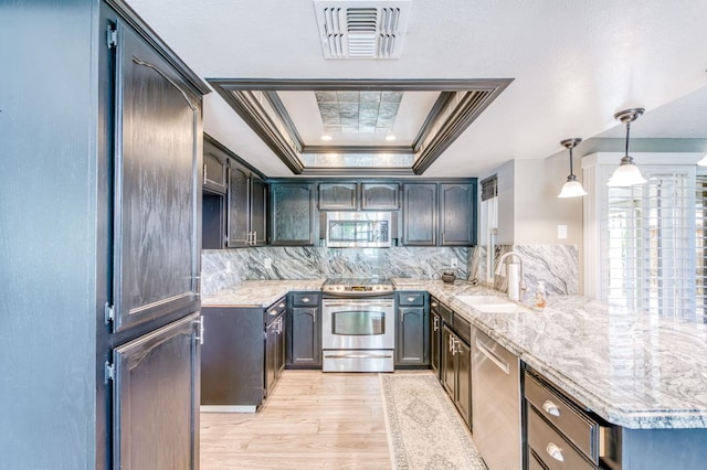 6211 N Cleo Ave, Fresno, CA 93722 - kitchen featuring stainless steel appliances, a sink, a peninsula, light wood-type flooring, and crown molding