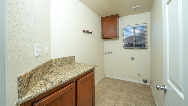 113 Palomino St, Coalinga, CA 93210 - laundry area featuring cabinet space, baseboards, light tile patterned floors, and hookup for an electric dryer