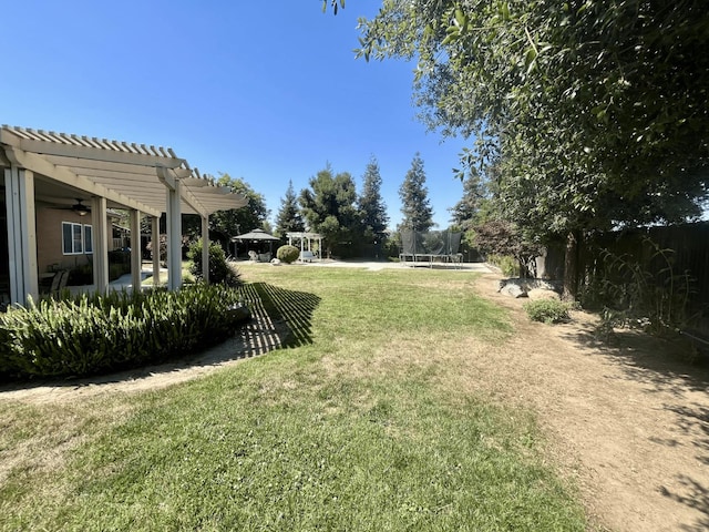 2604 W Taylor, Visalia, CA 93291 - view of grassy yard with a pergola, a trampoline, and a ceiling fan