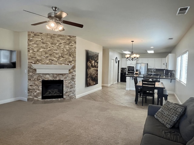 2604 W Taylor, Visalia, CA 93291 - living area with light colored carpet, ceiling fan, baseboards, a chandelier, and light tile patterned flooring