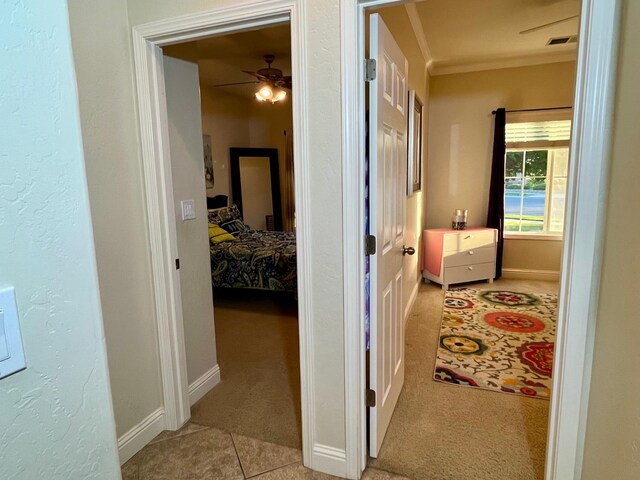 2604 W Taylor, Visalia, CA 93291 - hallway featuring light carpet, baseboards, ornamental molding, and light tile patterned floors