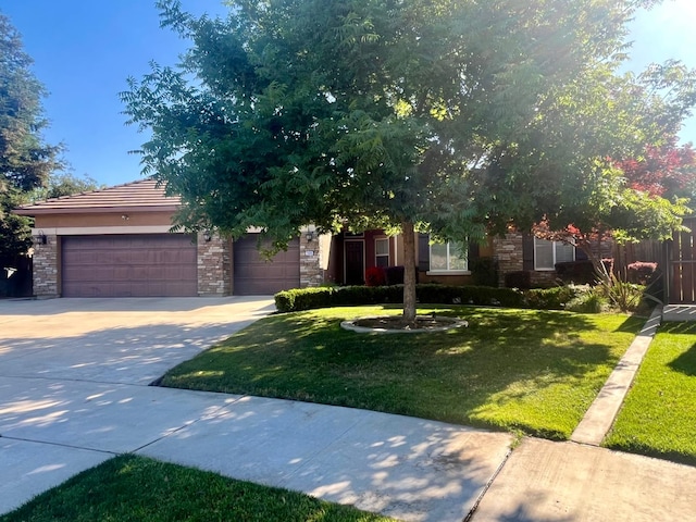 2604 W Taylor, Visalia, CA 93291 - view of property hidden behind natural elements featuring stone siding, concrete driveway, and a garage