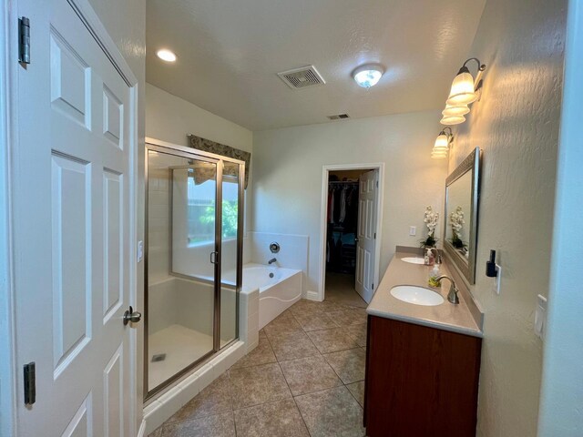 2604 W Taylor, Visalia, CA 93291 - bathroom with a shower stall, a bath, tile patterned floors, double vanity, and a walk in closet