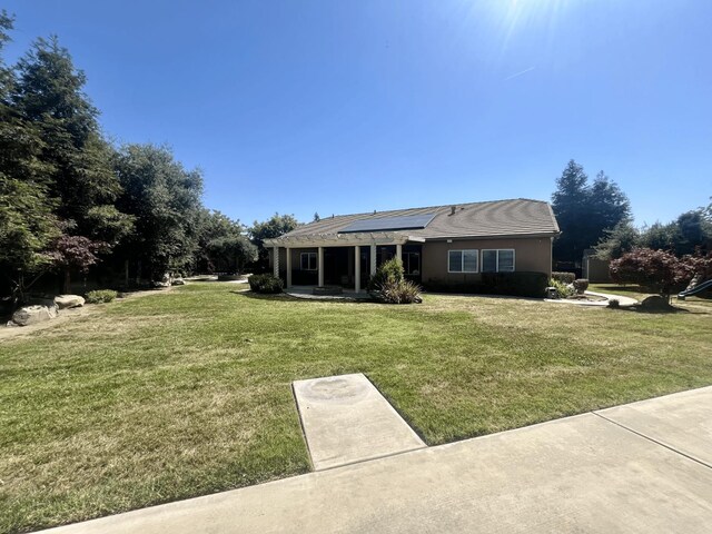 2604 W Taylor, Visalia, CA 93291 - view of front of house with roof mounted solar panels and a front lawn
