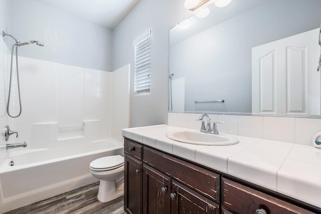 full bath with wood finished floors, toilet, vanity, and shower / bath combination