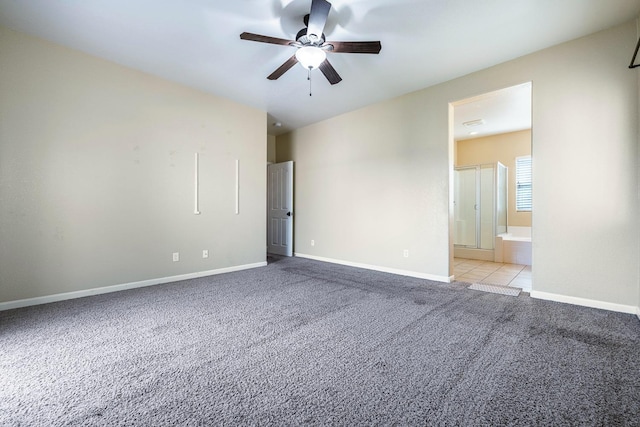 carpeted spare room with ceiling fan and baseboards