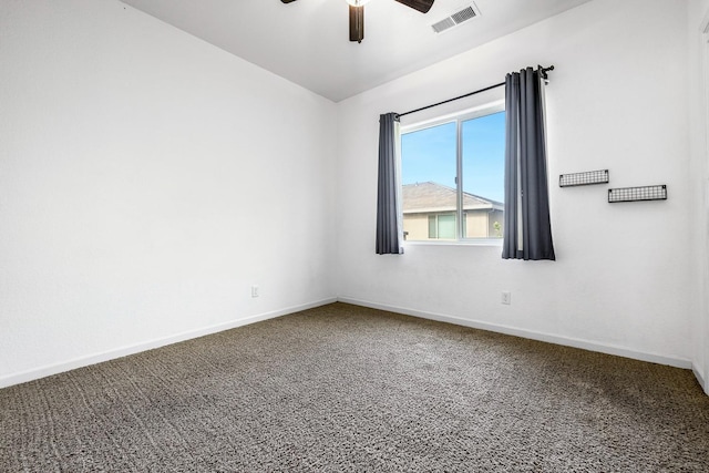 carpeted spare room featuring a ceiling fan and baseboards