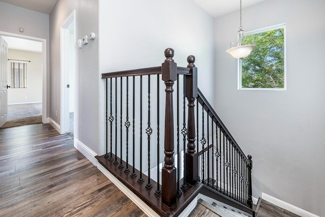 stairs featuring wood finished floors and baseboards