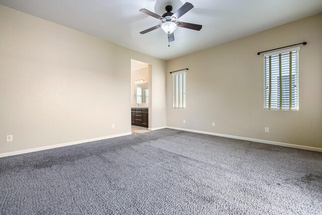 spare room featuring plenty of natural light, a ceiling fan, carpet floors, and baseboards