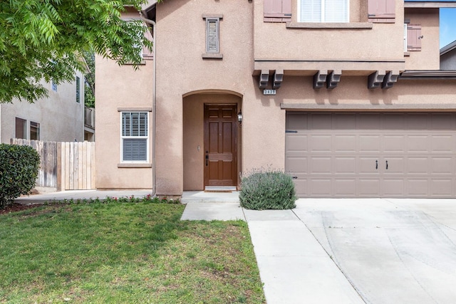 view of front of home featuring driveway, stucco siding, and an attached garage