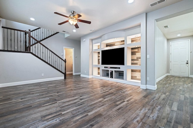 unfurnished living room with a ceiling fan, wood finished floors, stairs, baseboards, and recessed lighting