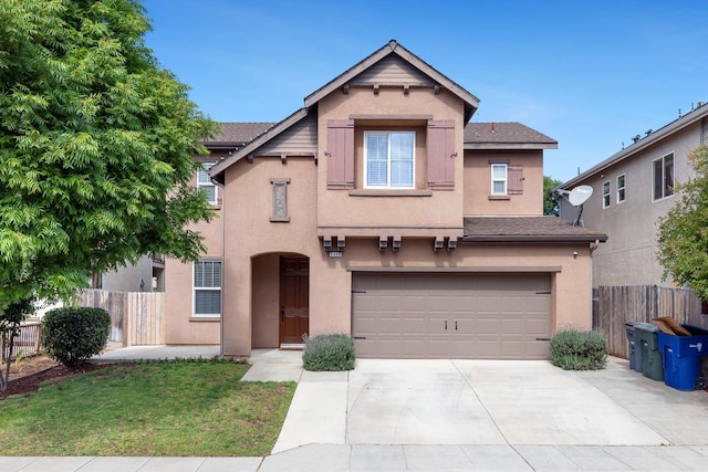 view of front facade with stucco siding, a garage, fence, and concrete driveway