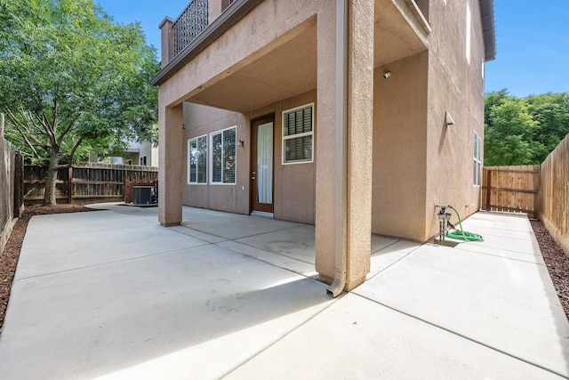 view of patio / terrace with central air condition unit and a fenced backyard
