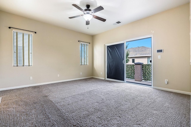 unfurnished room with healthy amount of natural light, a ceiling fan, and baseboards