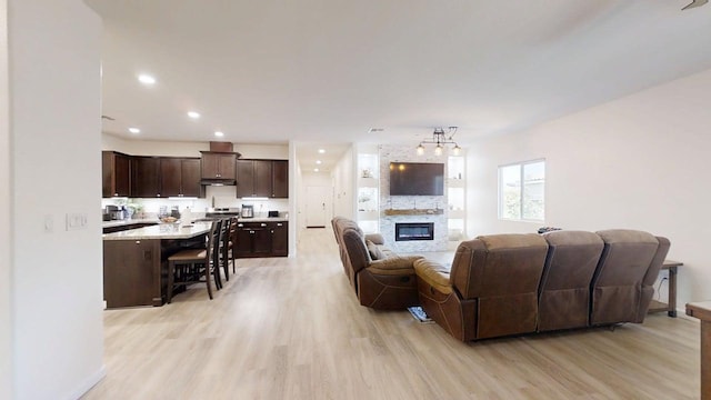 290 Cabrillo Dr, Coalinga, CA 93210 - living room with light wood-style floors, a fireplace, and recessed lighting